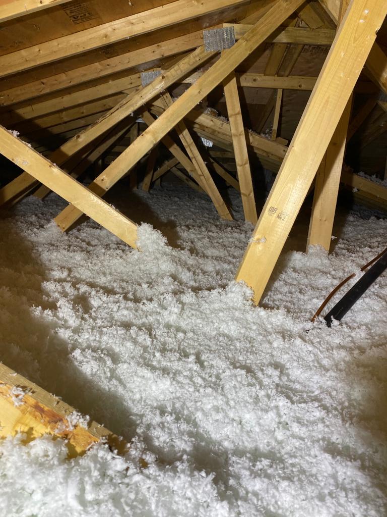 Mineral wool insulation application in progress