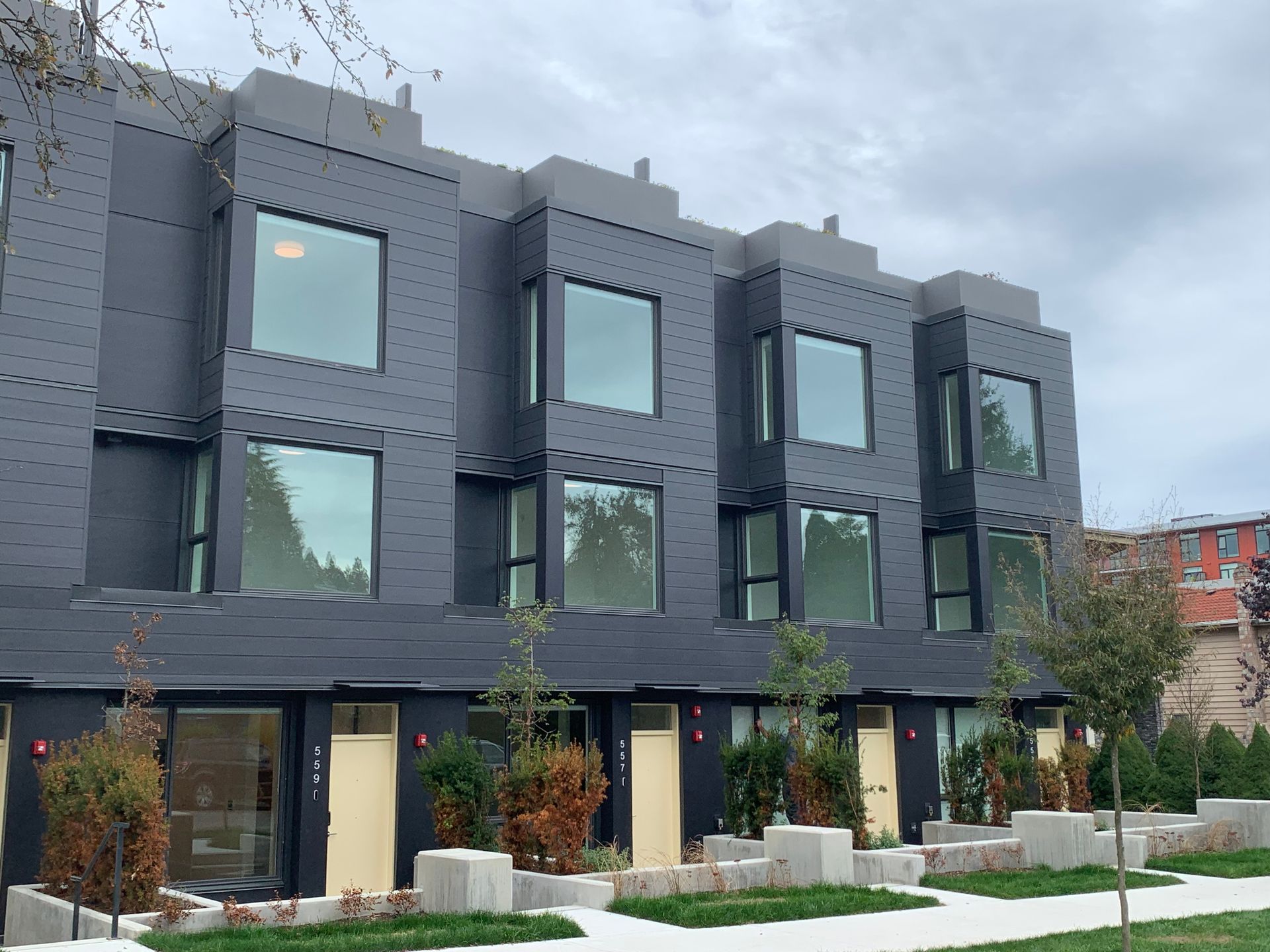 Contemporary townhouse development featuring modern dark gray siding and quality insulation work by Metro Standard Insulation